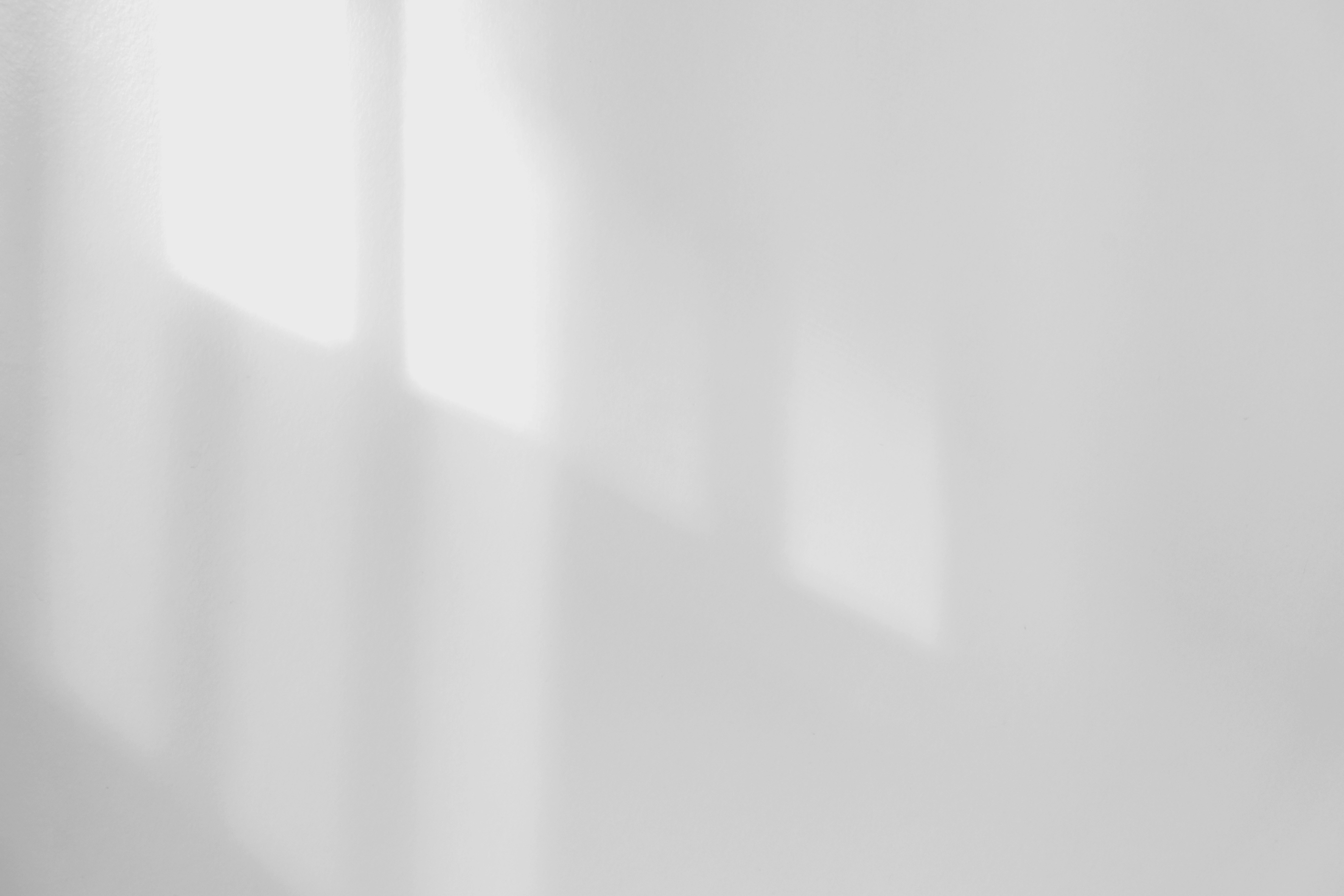 a black and white photo of a white wall