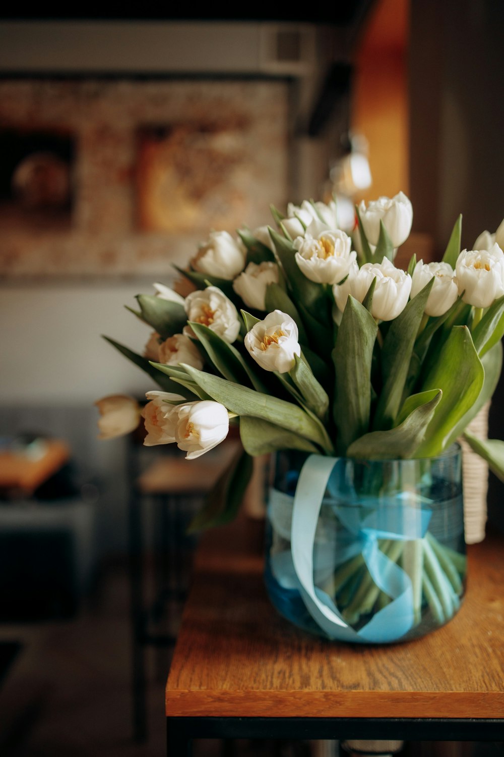 a bouquet of white tulips in a blue vase