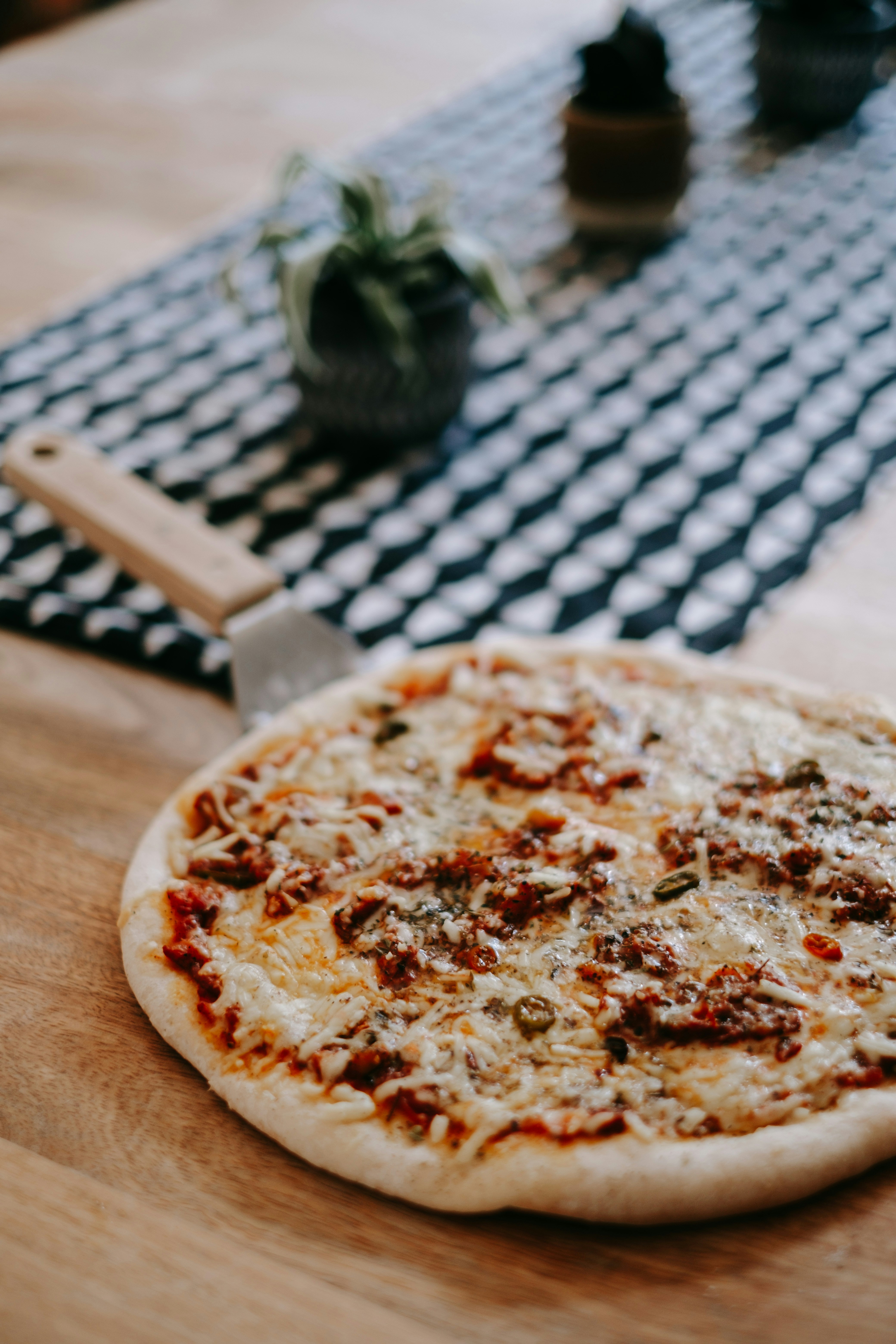 a pizza sitting on top of a wooden table