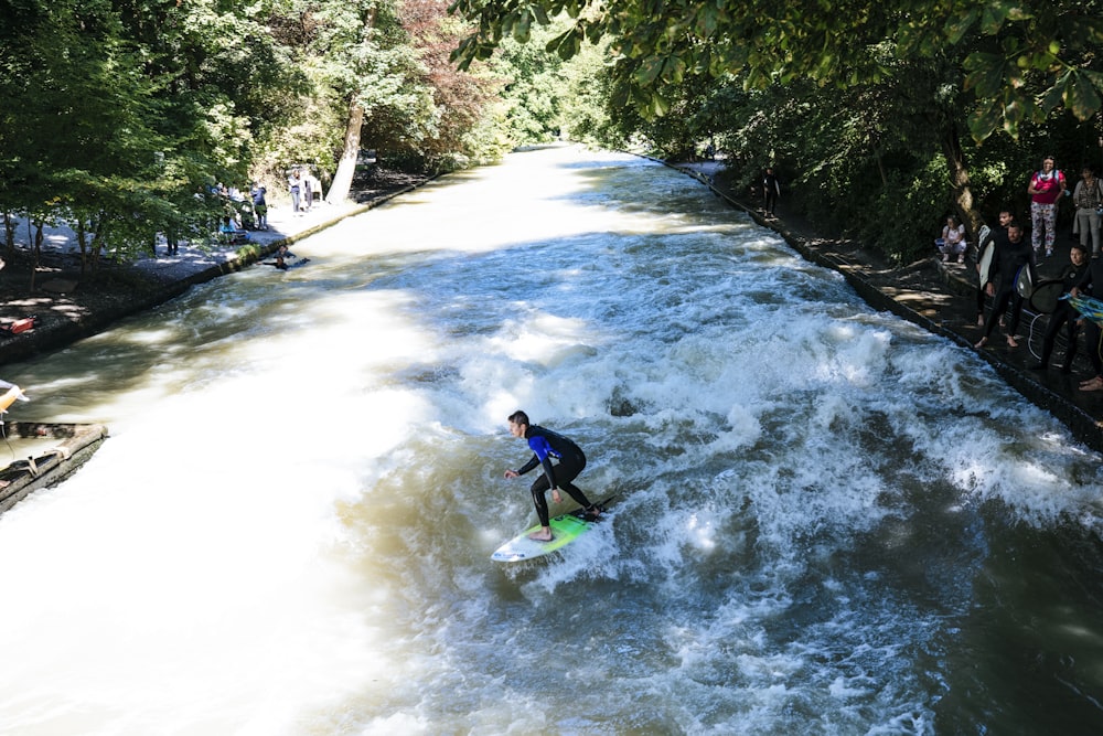 a man riding a wave on top of a surfboard