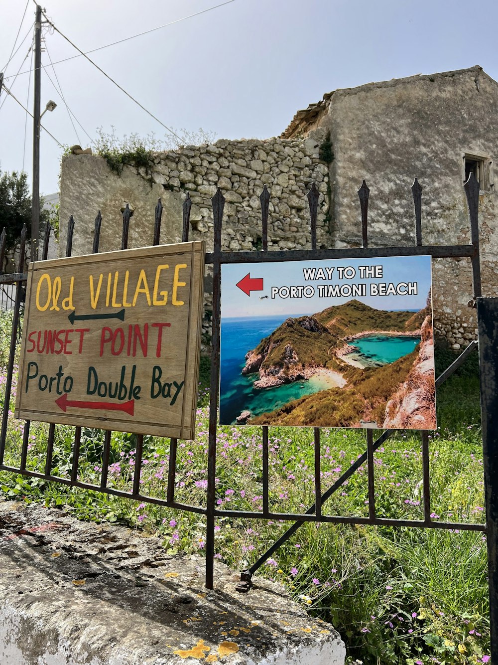 a sign is posted on a fence in front of a building