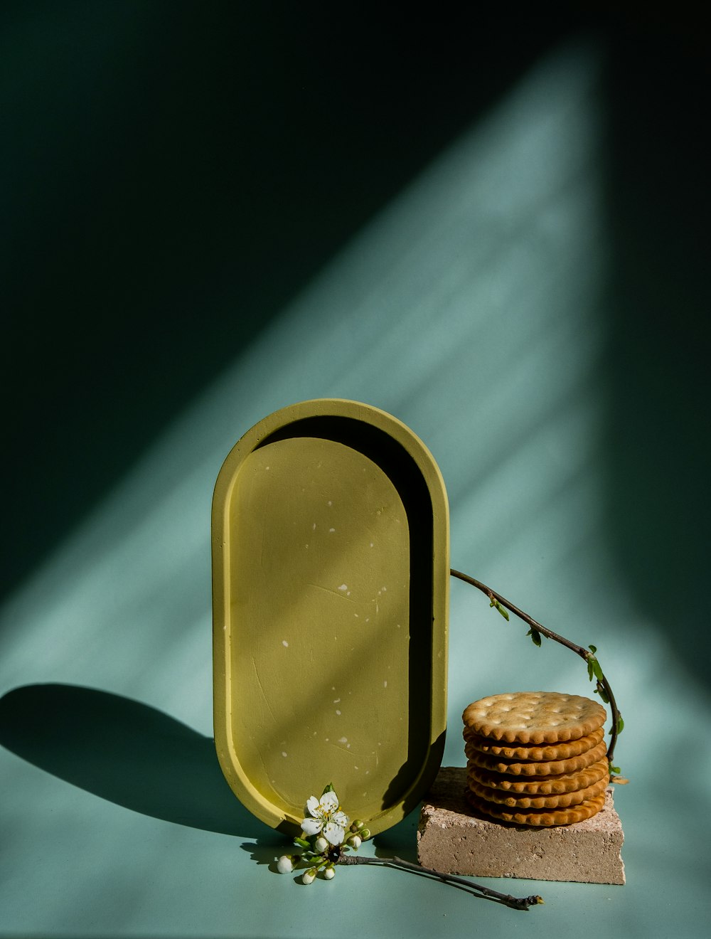 a stack of crackers sitting next to a yellow container