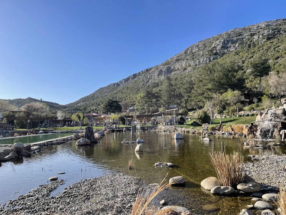 a lake surrounded by rocks and a mountain