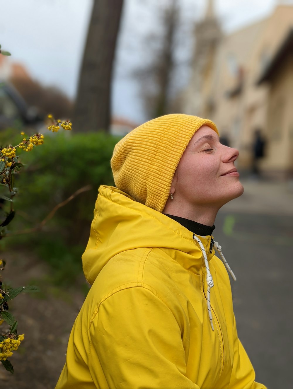 a woman wearing a yellow jacket and a yellow hat