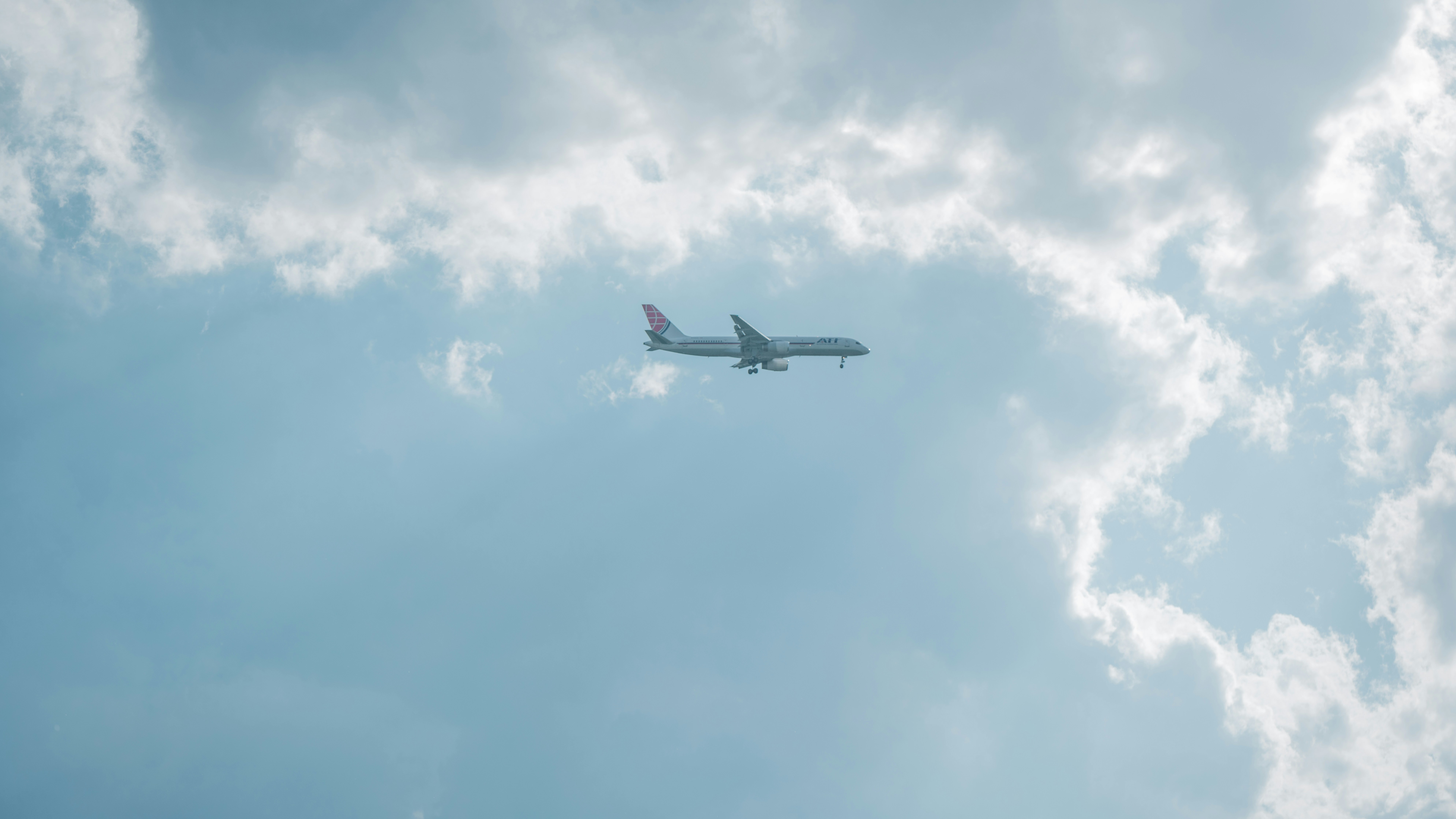 an airplane is flying through the cloudy sky