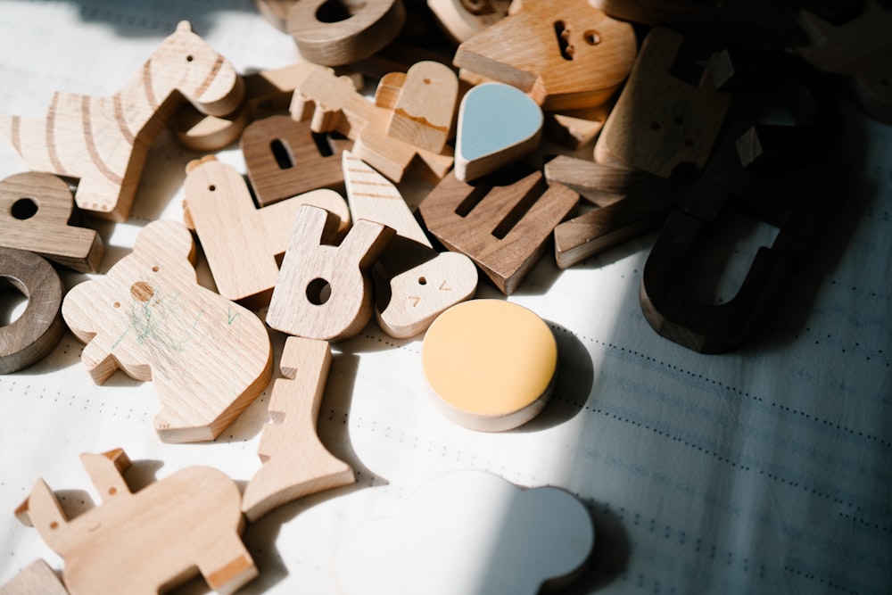 a pile of wooden toys sitting on top of a table