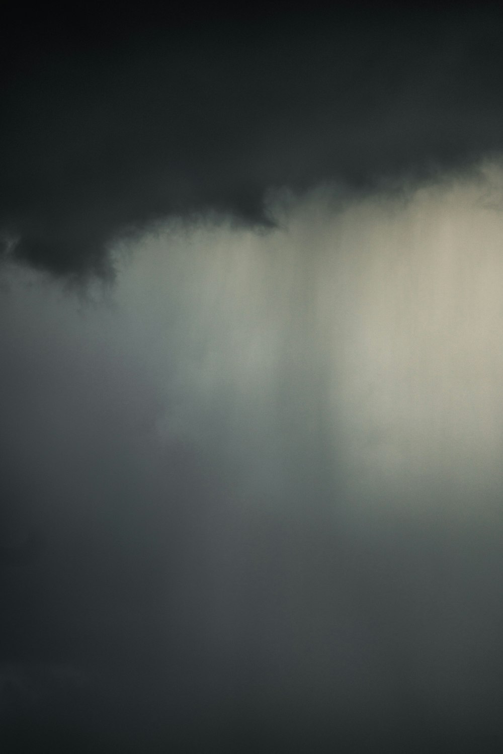 a plane flying through a dark cloudy sky