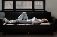 A person relaxing on a comfortable pillow in a sunlit room.