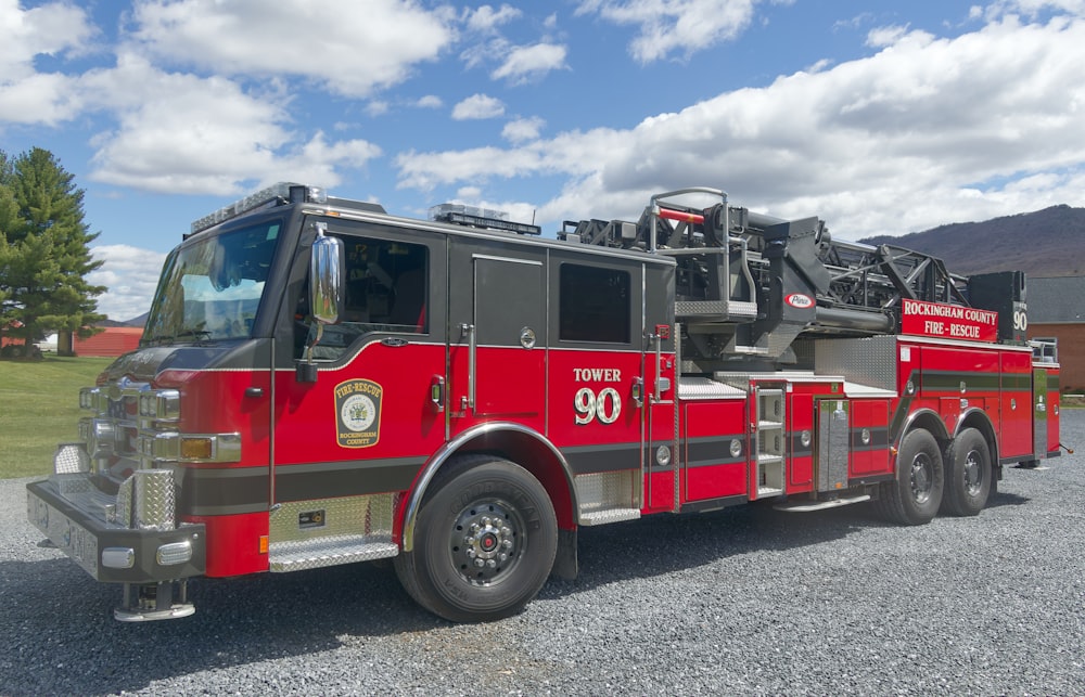 a red fire truck parked in a gravel lot