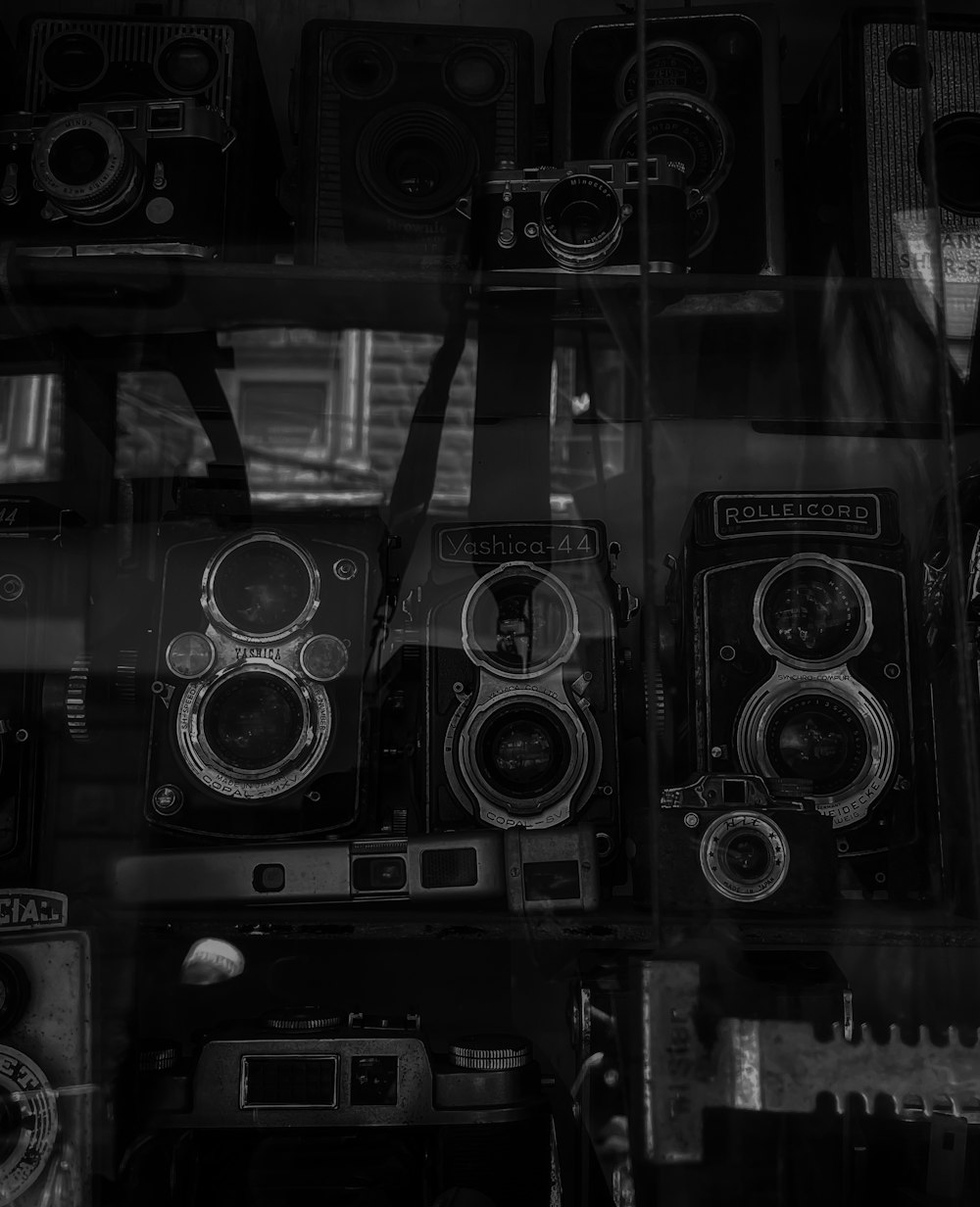 a bunch of old cameras sitting in a window