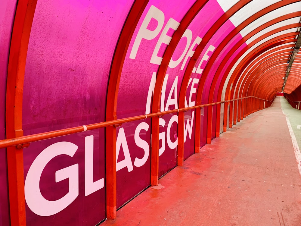 a red and white tunnel with a sign on it