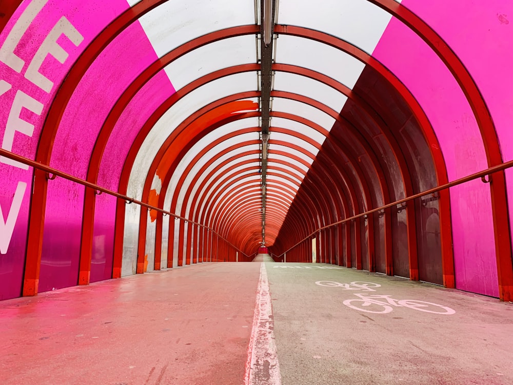 a pink tunnel with a bike path going through it