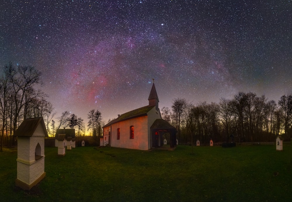 a church with a star filled sky in the background