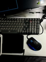 A stylish keyboard setup on a desk with a laptop.