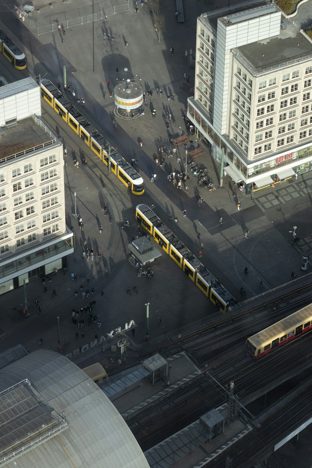 an aerial view of a city with a train station