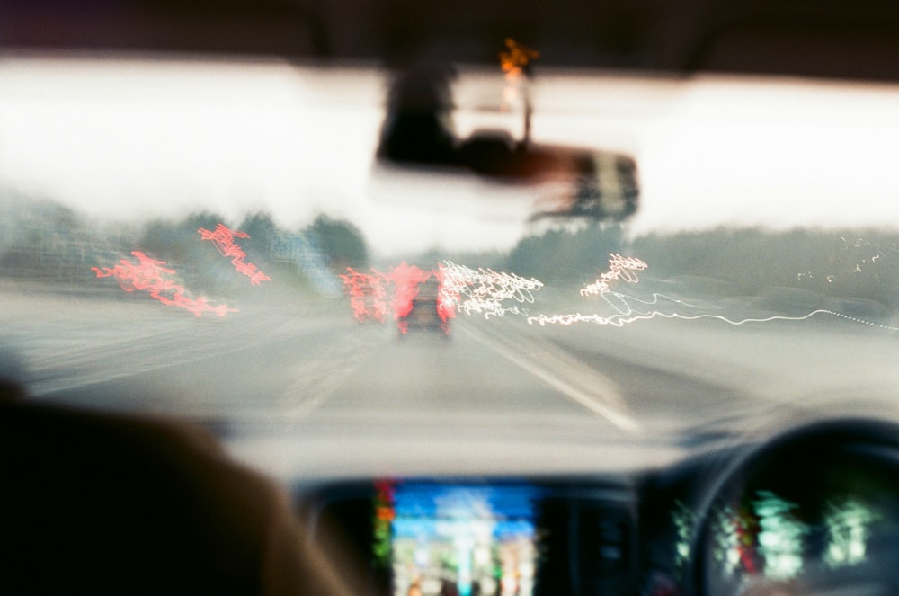 a blurry photo of a car driving down a street