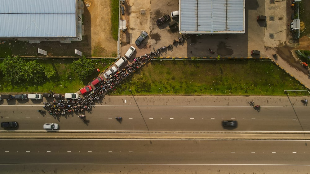 a group of people standing on the side of a road