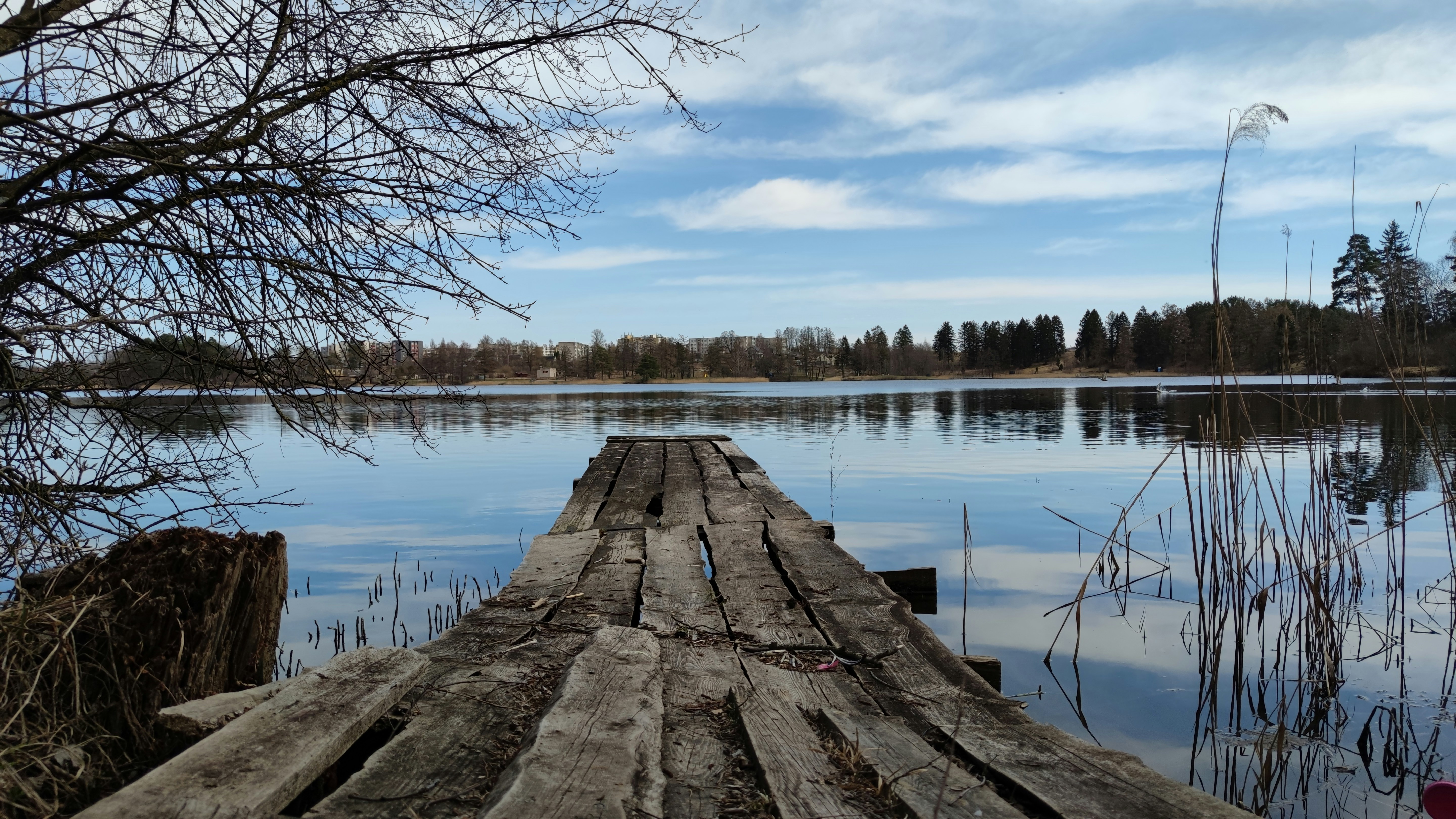 a wooden dock sitting in the middle of a lake