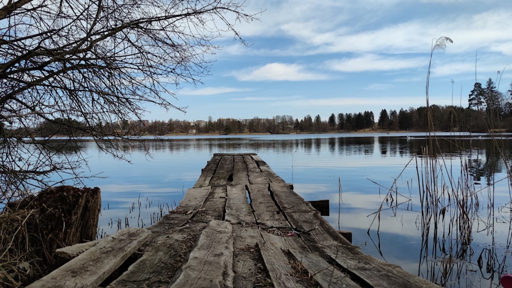 a wooden dock sitting in the middle of a lake