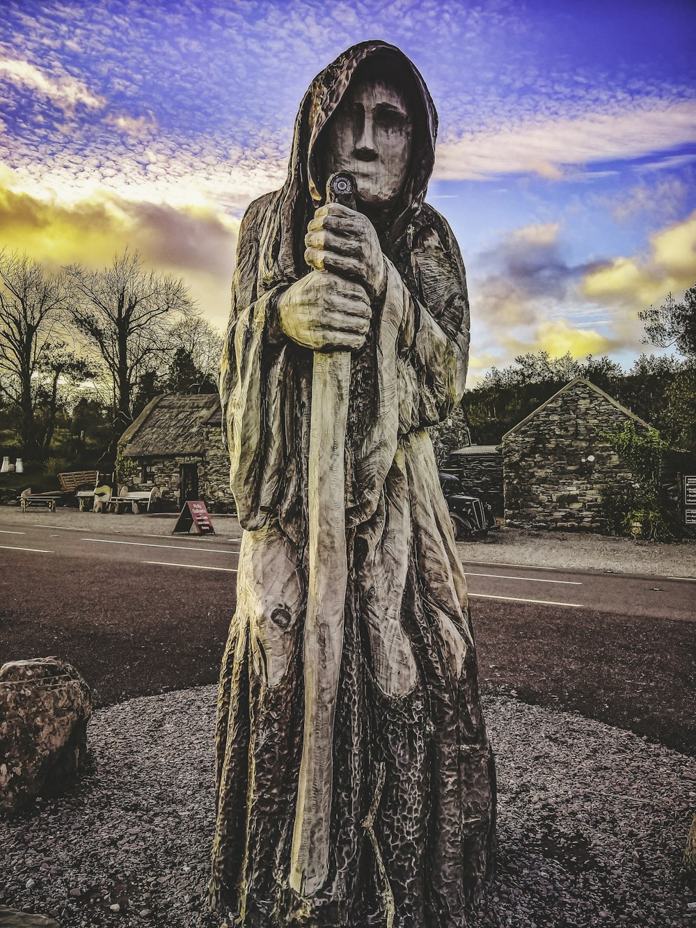 a statue of a person holding a stick