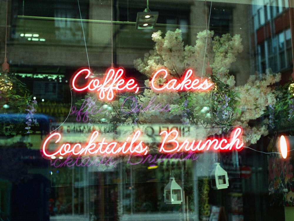 a window with a sign that says coffee cakes, cocktails, and brun