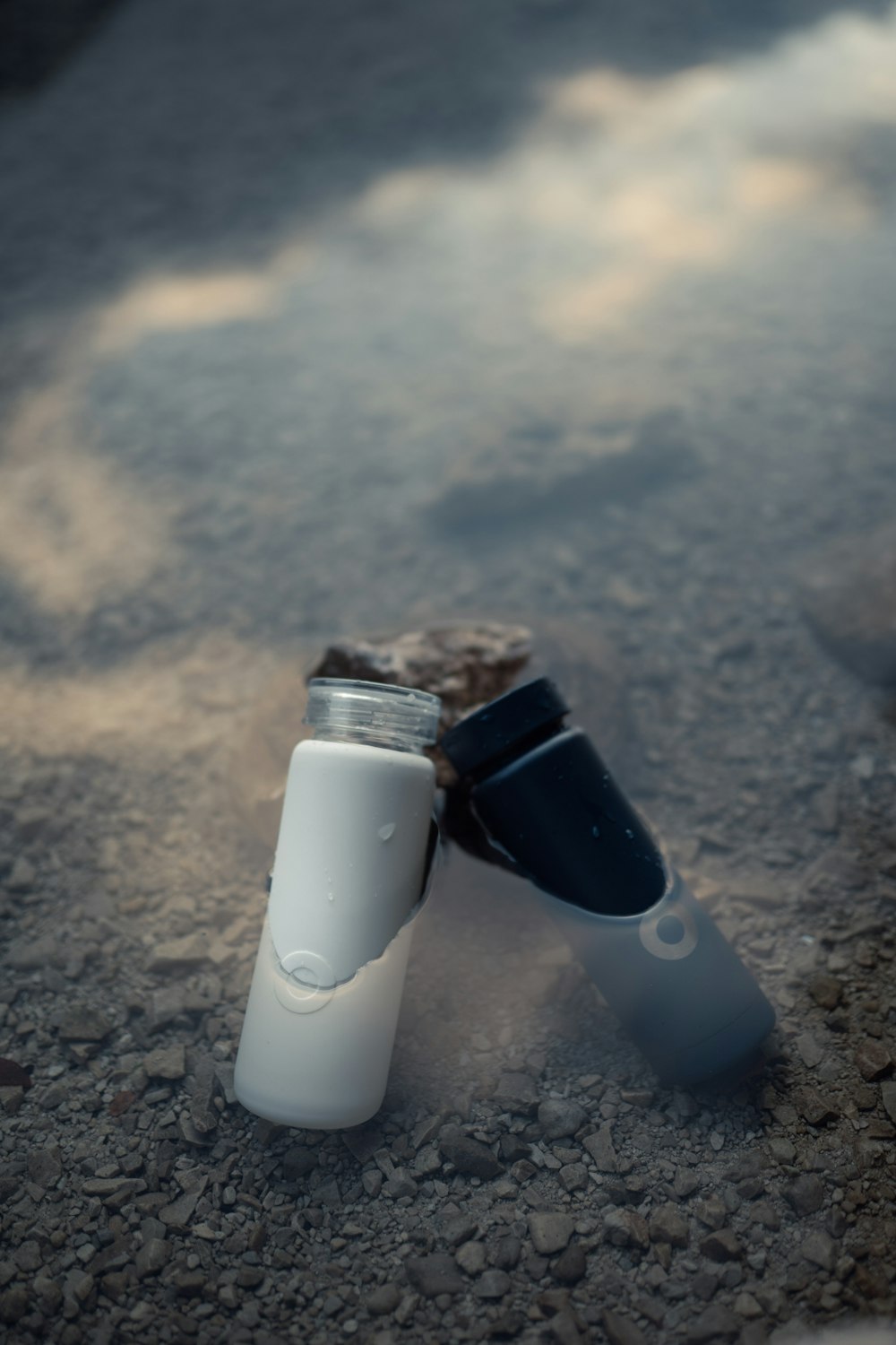 a toothbrush and a tube of toothpaste on the ground