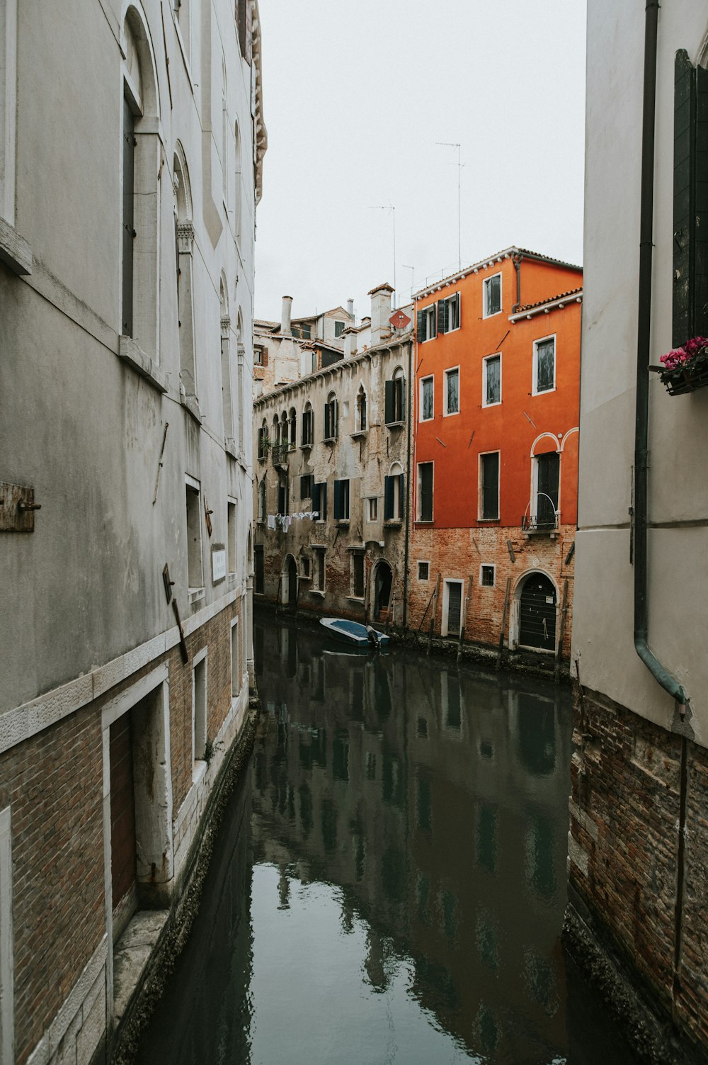 a canal running through a city next to tall buildings