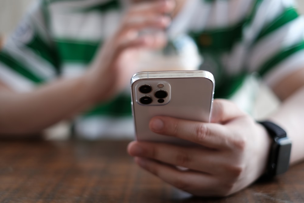 a close up of a person holding a cell phone