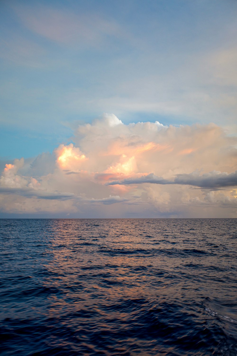 a large body of water under a cloudy sky