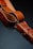 A close-up of a stylish leather belt displayed on a wooden table.