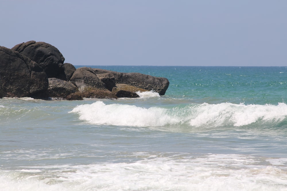 a person riding a surfboard on top of a wave