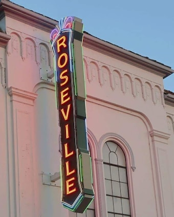 a neon sign on the side of a building