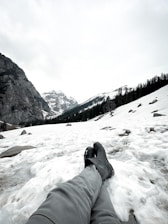 A cozy winter scene featuring a woman in warm boots enjoying a snowy landscape.