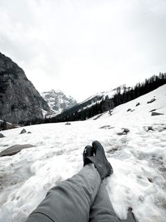A cozy winter scene featuring a woman in warm boots, enjoying a snowy landscape.