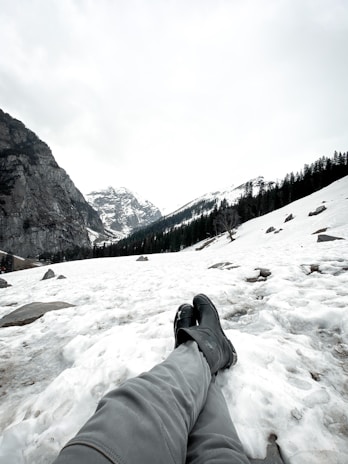 A cozy winter scene featuring a woman in warm boots, enjoying a snowy landscape.