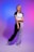 A person with long blonde hair stands in a poised, fashionable pose. They are wearing a black and white athletic outfit, consisting of a short-sleeved top and pants, set against a background featuring a gradient of blue to pink colors.