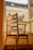 A beautifully crafted wooden chair set in a sunlit living room.