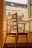 A beautifully crafted wooden chair set in a sunlit living room.