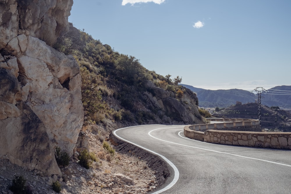 a curved road in the middle of a mountain