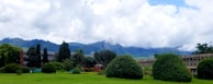 A lush green landscape surrounding a newly built energy-efficient building.