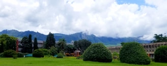 A lush green landscape surrounding a newly built energy-efficient building.