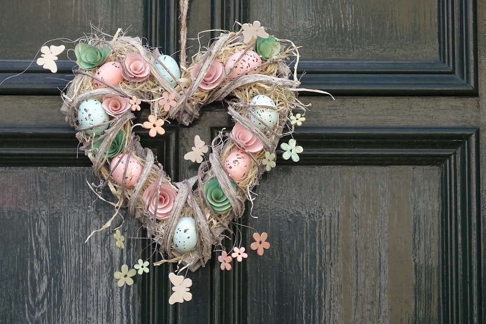 a heart shaped wreath hanging on a door