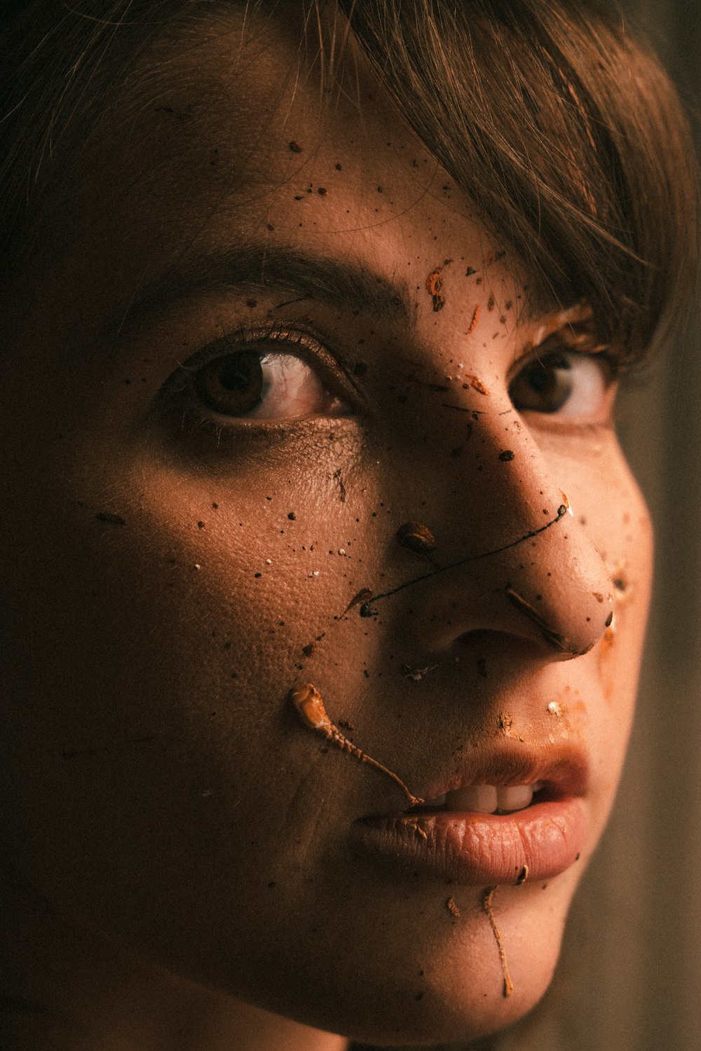 a woman with a piece of food on her face