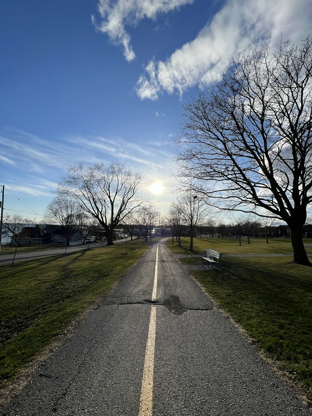 a road with a bench on the side of it