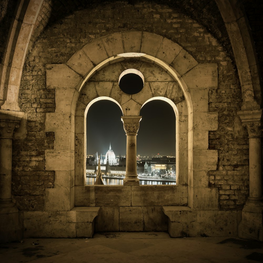 a window with a view of a city at night