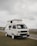 Photo of a Bolero Camper vehicle parked outside an industrial site under clear blue skies.
