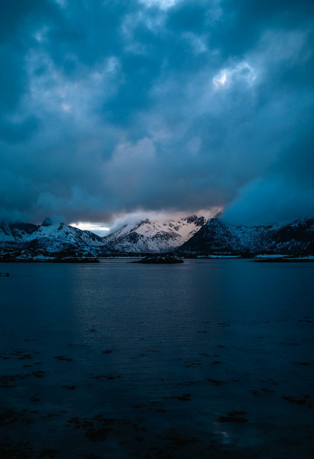 a large body of water under a cloudy sky