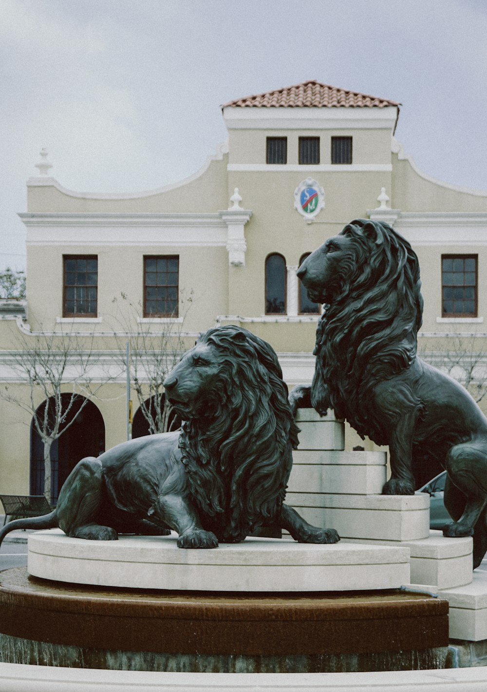 a statue of two lions in front of a building