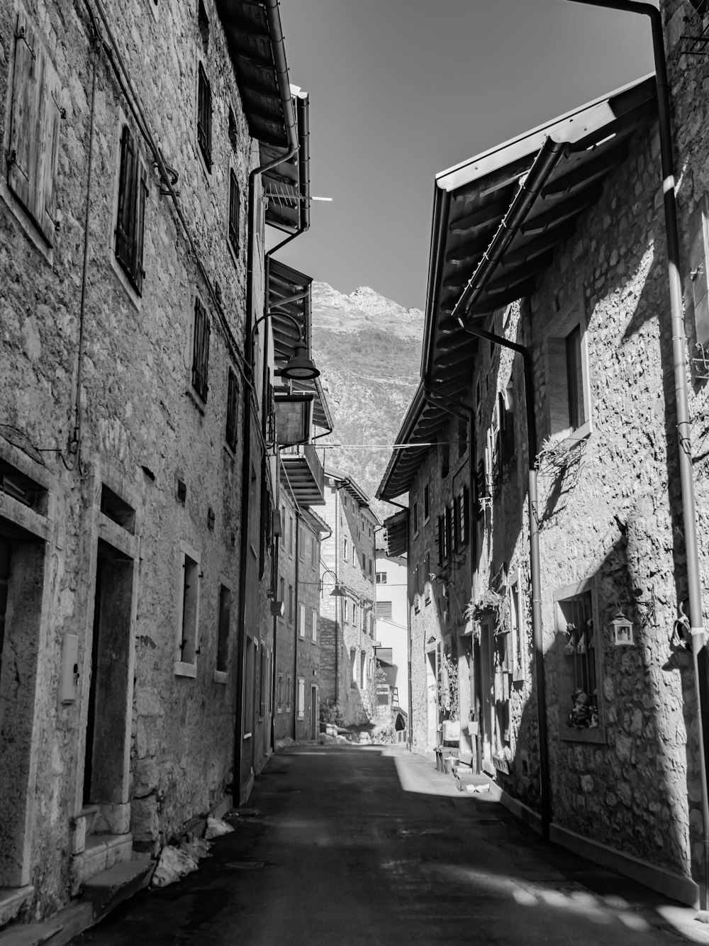 a black and white photo of a narrow street