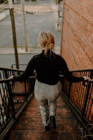 a woman walking down a flight of stairs